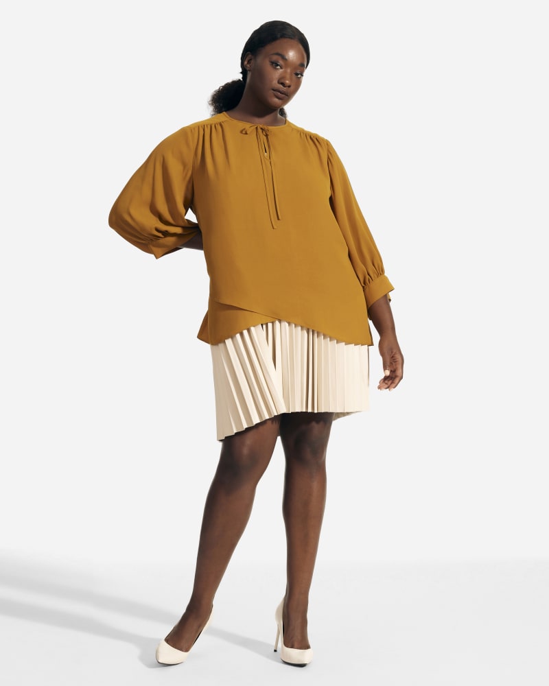 Front of a model wearing a size 1X Fatima Tie Neck Peasant Blouse in Mustard by T Tahari. | dia_product_style_image_id:229111